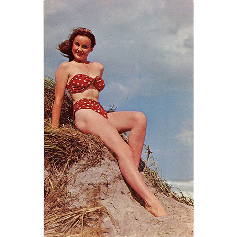 Brunette Bathing Beauty Red Polka Dot Bikini Sitting on Sand Dune Vintage Postcard (unused) - Vintage Postcard Boutique